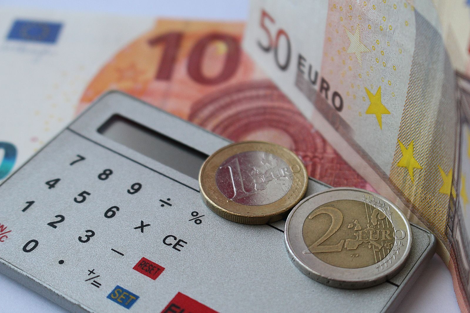 Calculadora y facturas sobre escritorio, cálculo de pagos del Estado